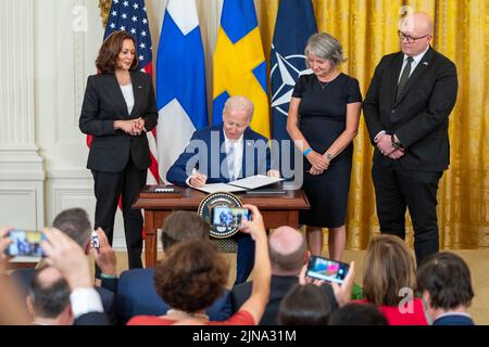 Washington, United States Of America. 10th Aug, 2022. Washington, United States of America. 10 August, 2022. U.S President Joe Biden, signs the Accession Protocols approving Sweden and Finland as the newest members of the North Atlantic Treaty Organization during a ceremony in the East Room of the White House August 9, 2022 in Washington, DC Standing left to right are: Vice President Kamala Harris, President Joe Biden, Swedish Amb. Karin Olofsdotter, and Finnish Amb. Mikko Hautala. Credit: Adam Schultz/White House Photo/Alamy Live News Stock Photo