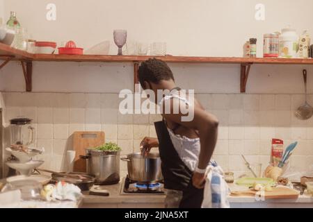 woman chef preparing african caribbean food with plantain plane tree fruit Stock Photo