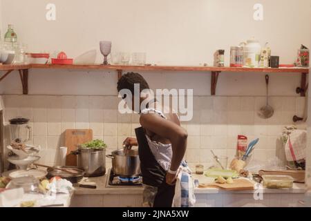 woman chef preparing african caribbean food with plantain plane tree fruit Stock Photo