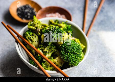 Close-up of a bowl of broccoli with sesame seeds and pink himalayan salt Stock Photo