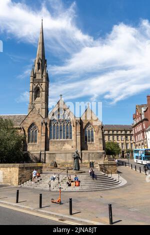 The Cathedral Church of St Mary - the Catholic cathedral in the city of Newcastle upon Tyne, UK, with a statue of Cardinal Basil Hume outside. Stock Photo