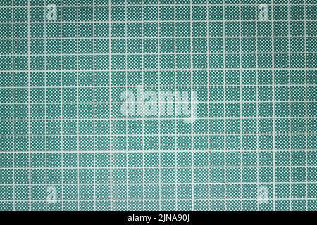 Image of the surface of a green craft cutting board with a grid Stock Photo