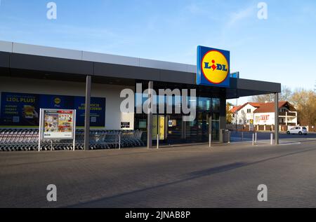 Lidl shop entrance with brand logo signboard. German international discount supermarket retail chain. Convenience grocery store, shopping center sign. Stock Photo