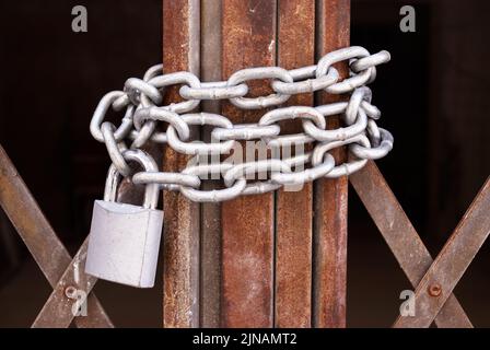 Closeup of a metal gate chained and locked Stock Photo