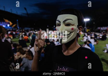 Pathum Thani, Thailand. 10th Aug, 2022. Demonstrator makes three finger salute while wearing an anonymous mask during the demonstration. Pro-democracy demonstrators gathered at Thammasat University, Rangsit Campus in Pathum Thani where they first mentioned about the monarchy reformation 2 years ago. Demonstrators demand the resignation of Thailand's prime minister, Prayuth Chan-ocha, and reforms to the monarchy. Credit: SOPA Images Limited/Alamy Live News Stock Photo
