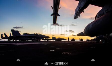 Pacific Ocean, United States. 08th Aug, 2022. U.S. Navy fighter jets are silhouetted as the sun rises over the flight deck of the Nimitz-class aircraft carrier USS Ronald Reagan underway, August 8, 2022 in the Philippine Sea. Credit: MC3 Oswald Felix Jr./Planetpix/Alamy Live News Credit: Planetpix/Alamy Live News Stock Photo