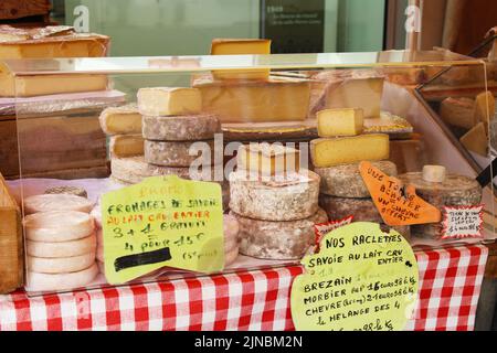 Traditional French cheese stall on the  food market in France Stock Photo