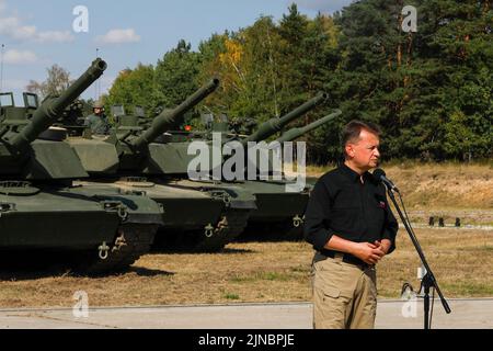 Biedrusko, Poland. 10th Aug, 2022. Polish Defense Minister Mariusz Blaszczak delivers remarks during the opening ceremony of the Abrams Tank Training Academy at the Land Forces Training Center August 10, 2022 in Biedrusko, Poland. The Abrams Tank Training Academy was established to teach Polish tank crewmen on operations, tactics and maintenance of the M1 Abrams main battle tank. Credit: Spc. Hassani Ribera/U.S Army/Alamy Live News Stock Photo
