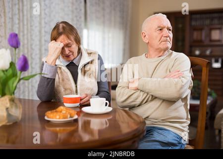 Senior couple after quarrel in living room Stock Photo