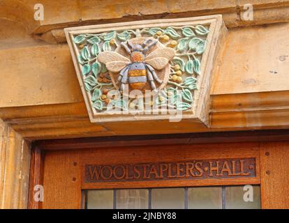 Historic woolstaplers hall, carved wood entrance,worker bee, Chipping Camden, Cotswolds market town, Cotswold, Oxfordshire, England, UK, GL55 6AA Stock Photo