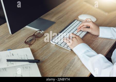 Close up of business woman hands working using keyboard of computer in office workplace Stock Photo