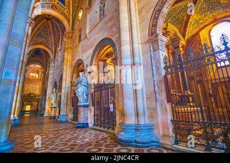 CERTOSA DI PAVIA, ITALY - APRIL 9, 2022: The side chapels with altarpieces and colorful decorations in the main hall of the church of the monastery, o Stock Photo