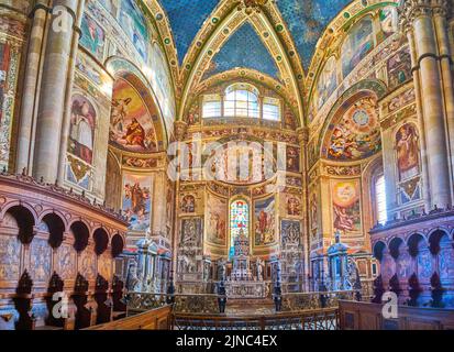 CERTOSA DI PAVIA, ITALY - APRIL 9, 2022: The high Altar in colorful presbytery of Certosa di Pavia monastery, on April 9 in Certosa di Pavia, Italy Stock Photo