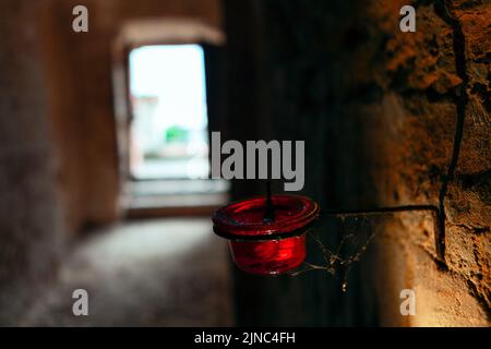 Candle lamp in the cellar . Old brick wall in dim light Stock Photo