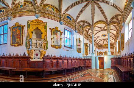 CERTOSA DI PAVIA, ITALY - APRIL 9, 2022: Panorama of the Refectory hall with large pictures and frescoes on ceiling, Certosa di Pavia monastery, on Ap Stock Photo