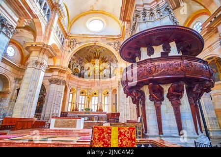 PAVIA, ITALY - APRIL 9, 2022: The wooden pulpit with carved saints, Duomo di Pavia, on April 9 in Pavia, Italy Stock Photo
