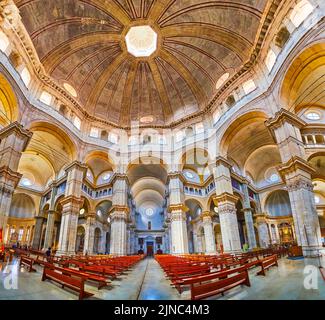 PAVIA, ITALY - APRIL 9, 2022: Panoramic view on the large prayer hall of Cathedral of Pavia with huge cupola above, on April 9 in Pavia, Italy Stock Photo
