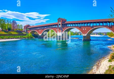 The scenic covered Ponte Vecchio or Ponte Coperto Bridge over Ticino river in Pavia city, Italy Stock Photo