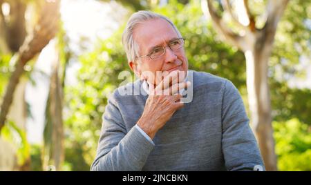 Things could have definitely turned out better. a senior man looking thoughtful at the park. Stock Photo