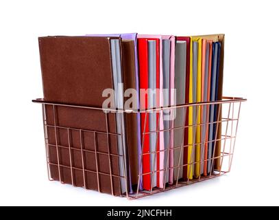 Pink metal basket with books on white background Stock Photo