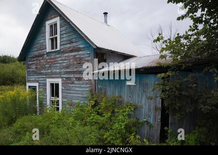 Old abandoned two story house in a field. Stock Photo