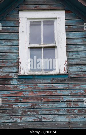 Close-up of glass pane window on old abandoned house. Stock Photo