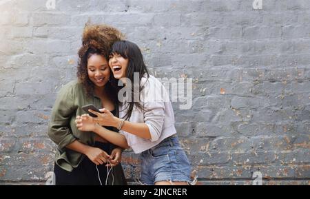 Woman Laughing against wall Stock Photo - Alamy
