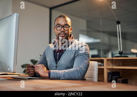 Hes not playing any games about his business. Portrait of a focused young businessman working in his office. Stock Photo