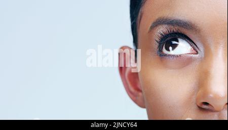 Is there anyone up there. Closeup beauty shot of a young womans eye. Stock Photo