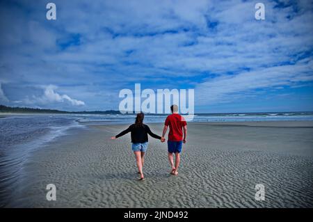 Mature couple walking on beautiful beach in Tofino, Canada Stock Photo