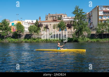 Plasencia, Spain - April 17, 2021: A young man practices canoeing riding in his canoe navigating the Jerte river Stock Photo
