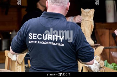 Pattensen, Germany, June 4, 2022: Rear View of Black Dressed Employee of a Security Company Stock Photo