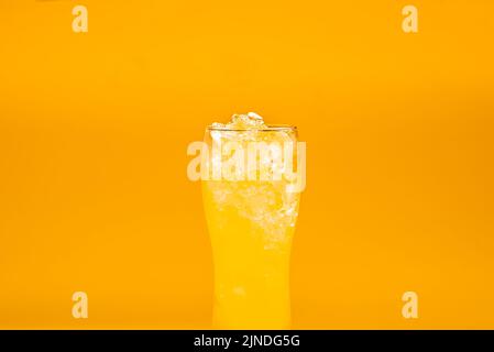 Beer cocktail yellow in a beer glass on a yellow background Stock Photo