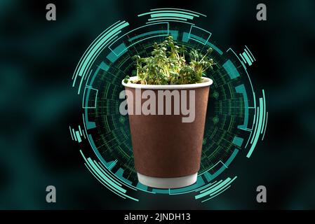 the smart farm. the concept of agriculture of today and the future. Eco cup with green vapors with computer graphics on a black background Stock Photo