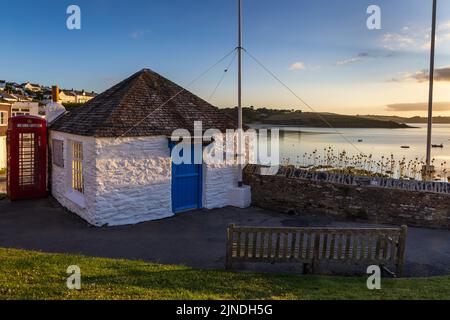 The Old Fishermen's Shelter in Portscatho, Cornwall. This pretty one-roomed little building is on the clifftop overlooking the harbour at Portscatho. Stock Photo