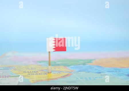 Selective focus of Bahrain flag in blurry world map and wooden airplane ...
