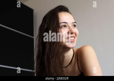 Portrait of happy young girl with long hair. Female beauty, skin and hair care Stock Photo