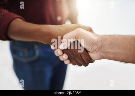 Closeup handshake showing success, support and trust between collaborating businessmen. Fingers of creative office business colleagues making a deal Stock Photo