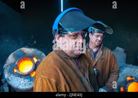 Foundry workers in a small family metal casting foundry in Perth, Western Australia Stock Photo