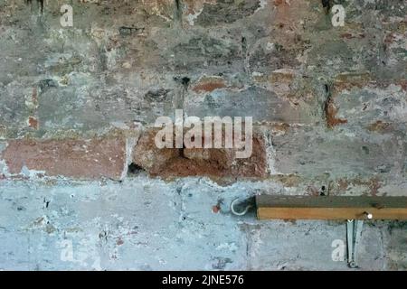 Crumbling brick wall masonry in old Victorian house in need of repointing repair work Stock Photo