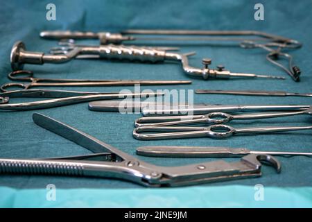 Set of steel surgical tools on blue cloth - real instruments used in mobile medical army tent Stock Photo