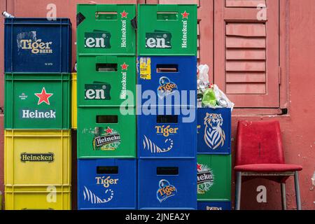 Empty beer crates are stacked neatly outside a bar in Boat Quay, Singapore. Horizontal Shot. Stock Photo