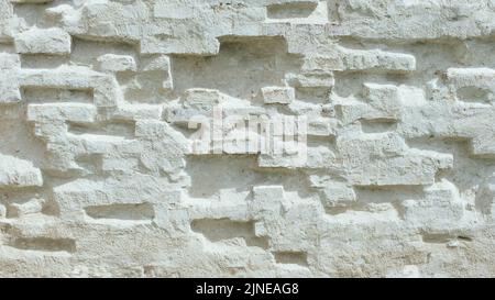 A brick wall painted with white primer is the wall of an old manor house Stock Photo