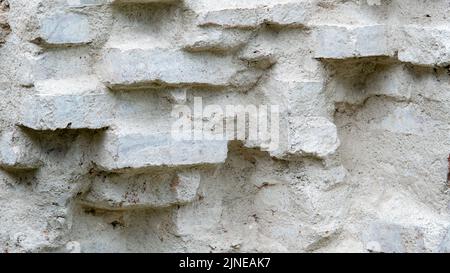 A brick wall painted with white primer is the wall of an old manor house Stock Photo