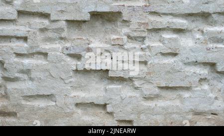 A brick wall painted with white primer is the wall of an old manor house Stock Photo