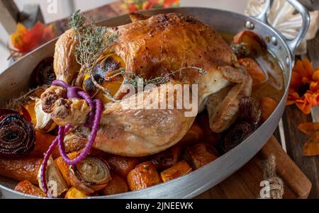 Thanksgiving roast chicken over roasted vegetables Stock Photo