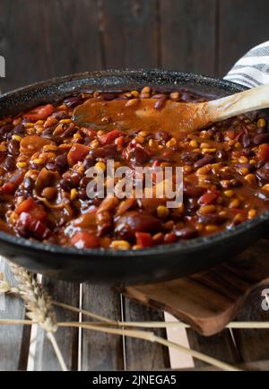 Vegan bean dish with a spicy mexican stew. Served in a frying pan. Chili sin carne Stock Photo