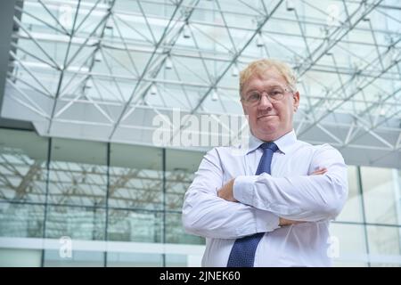 Portrait of confident middle-aged entrepreneur looking at camera Stock Photo