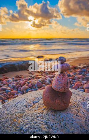 Stone tower on the beach with evening sunset light Stock Photo
