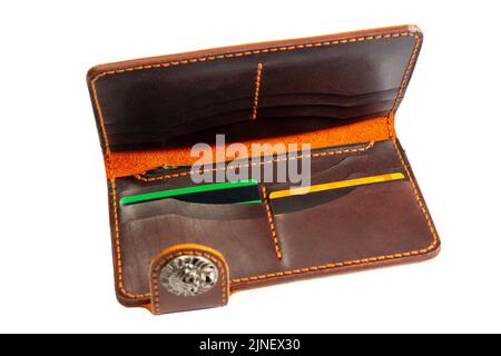 Open red leather clutch with money and credit cards isolated on white background. Stock Photo